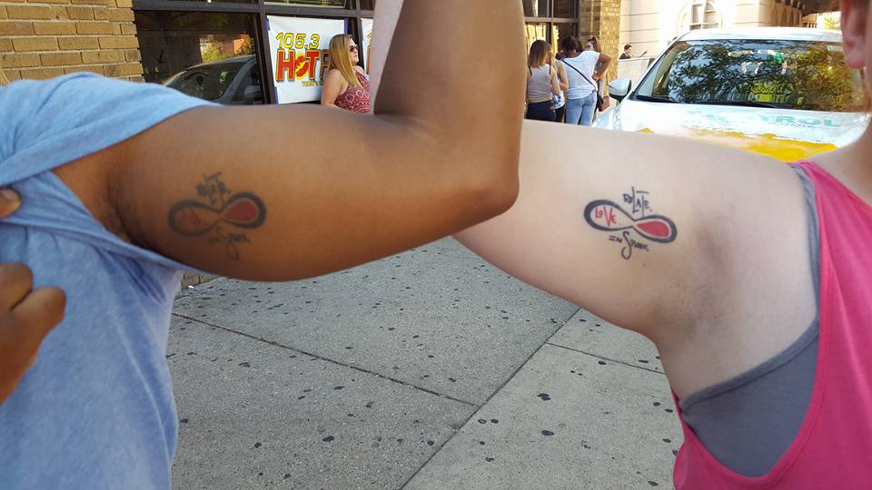 Fans' Matching Inner Bicep Tattoos Featuring Mike Posner's "Relate. Love. Inspire." Quote and Infinity Logo (2016) (2 of 2)
