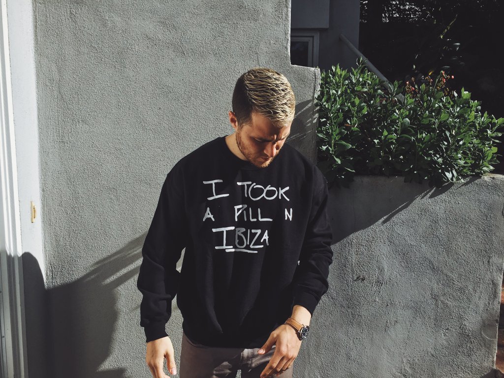 Mike Posner wearing his "I Took A Pill In Ibiza" limited edition charity sweatshirt in black
