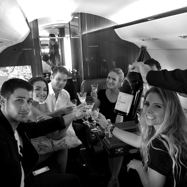 Mike Posner with Nick Jonas and Friends on a private jet headed to Vegas, NV 7/26/2014
You can't see Mike's face, only his hair. He's on the far right behind the bottle of champagne.
Instagram @nickjonas
